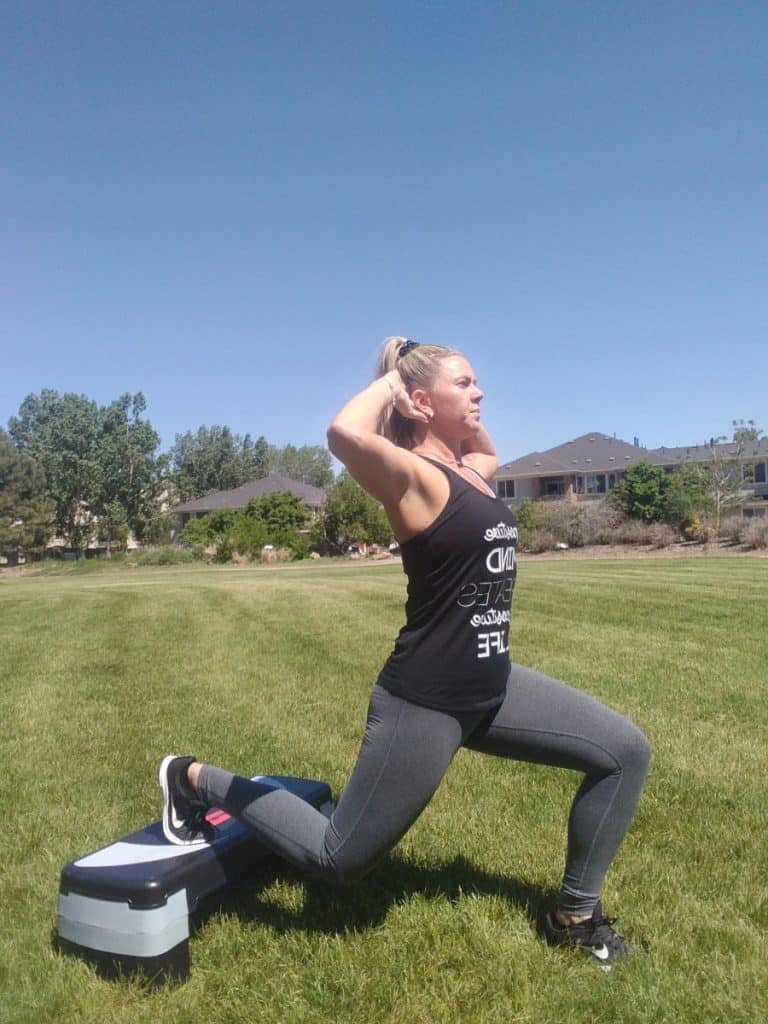 Shelby Doggett from Live For This Fitness performing lunges outside on grass